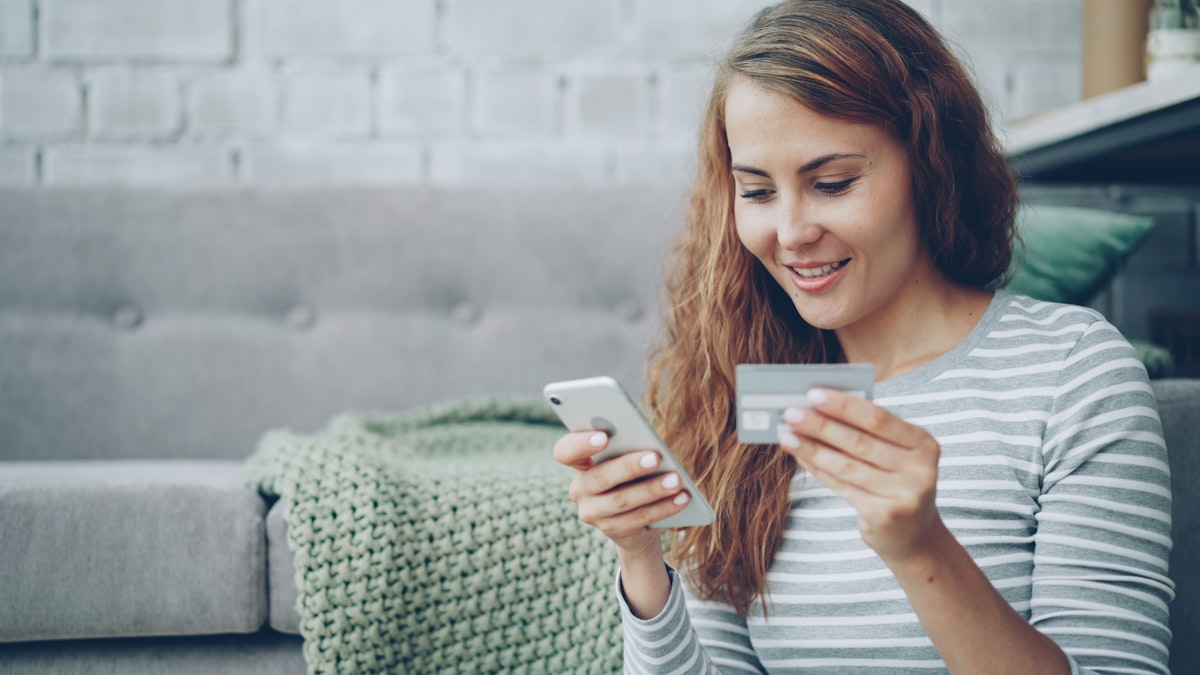 Young person holding their first credit card